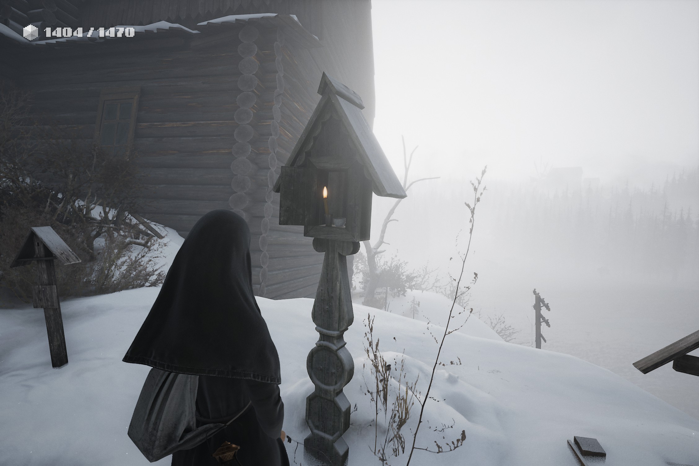 Indika, dressed in the black religious habit of a nun, stands in snow covered cemetery. She faces a wooden shrine in which is a lit candle. A wooden house is seen in the background, while the horizon fades into a bleak whiteness.